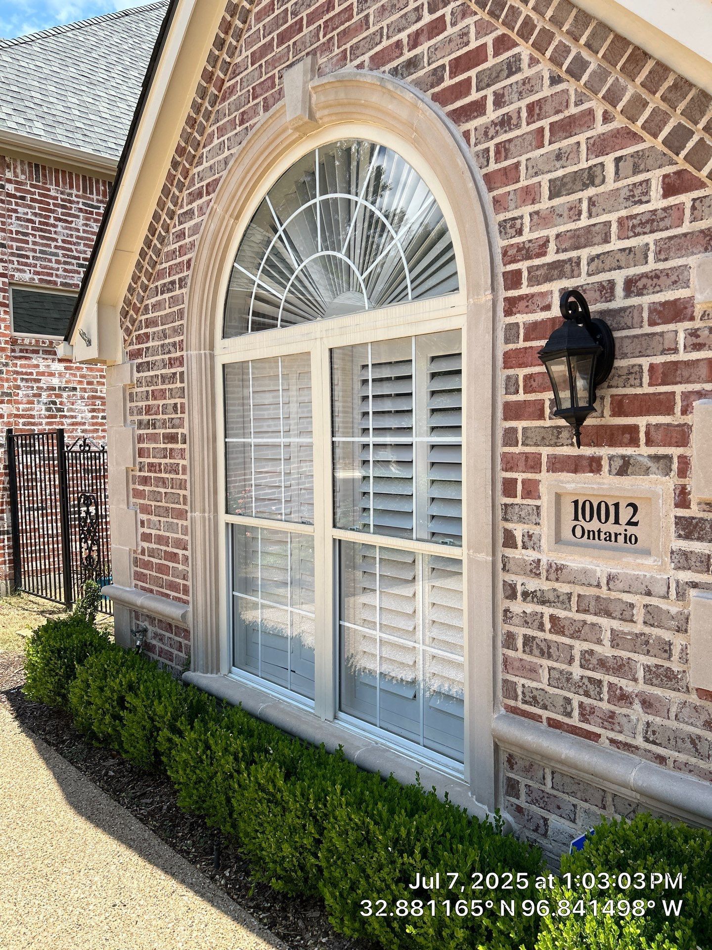 Arched window with shutters on a brick home, a real Jerco job